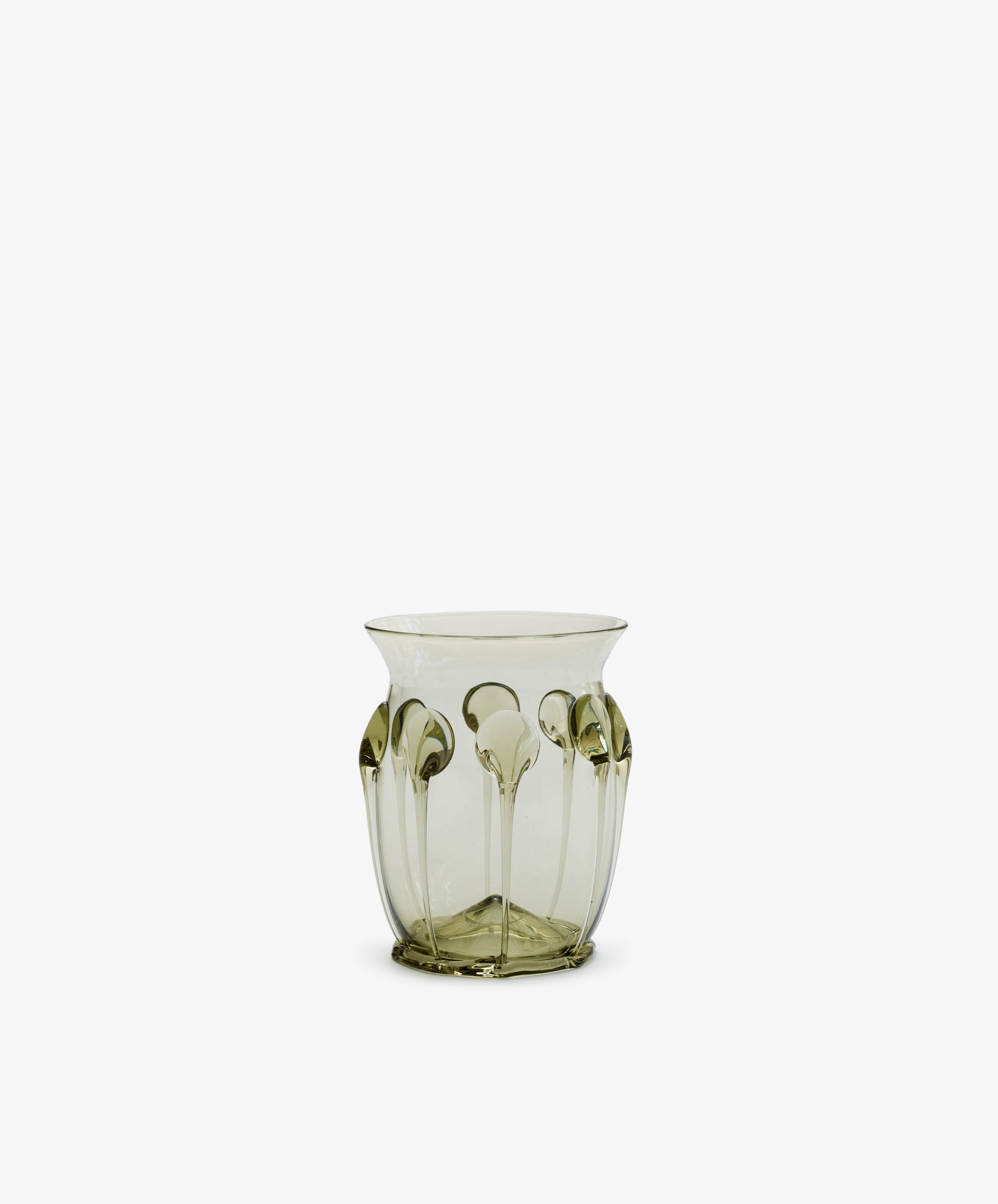 The Carlotta Vase is a translucent, mouth-blown piece with a pale green tint and raised vertical patterns along its sides, displayed against a plain white background.