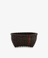 A medium-sized Love Basket, handwoven in dark brown with a slightly rounded base and a few orange accent strips, is displayed against a plain white background.