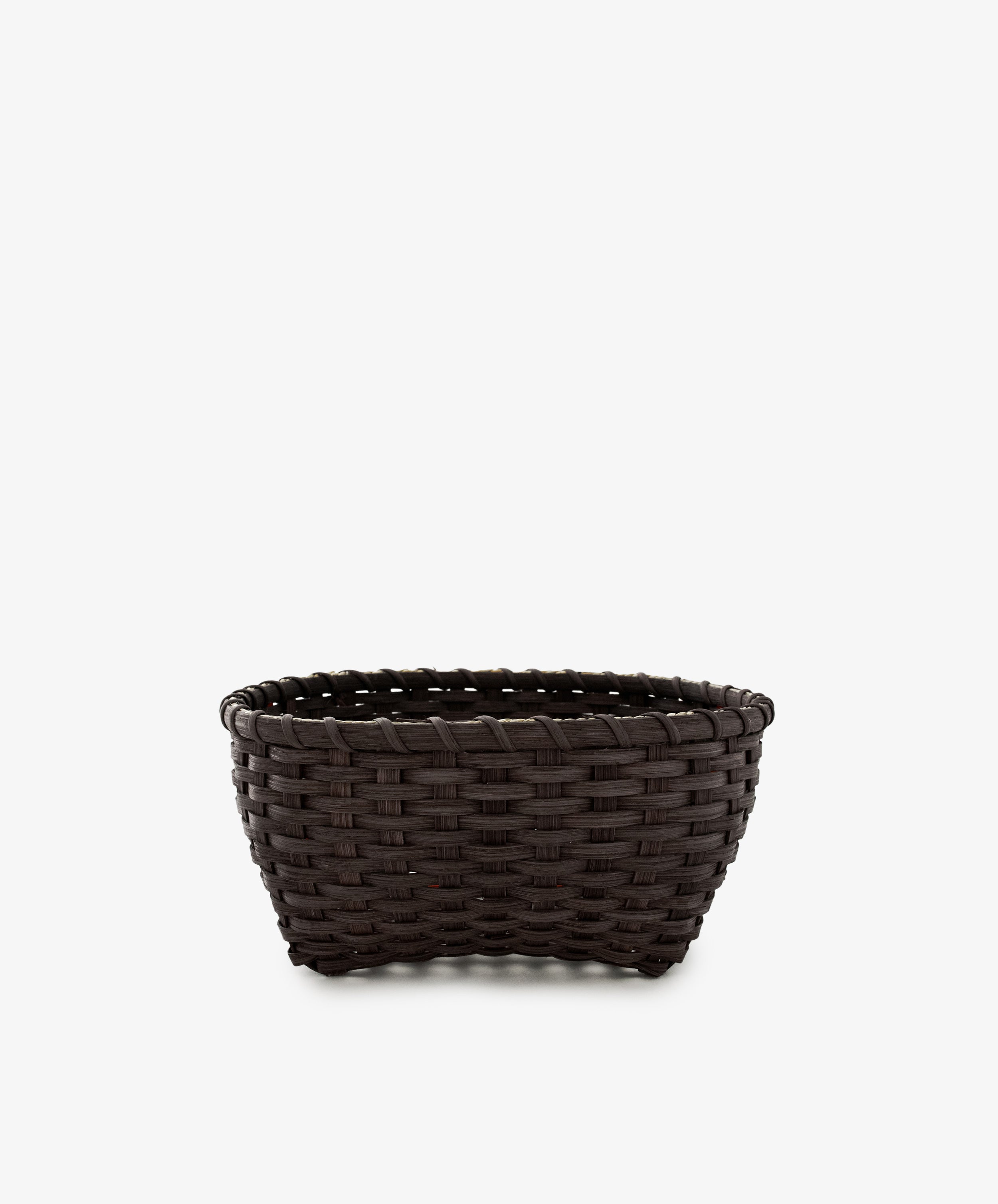 A medium-sized, dark brown handwoven Love Basket is placed against a plain white background.