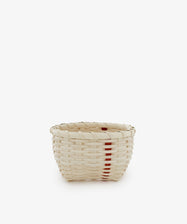 The Little Love Basket is a small handwoven basket in natural beige with a single vertical red stripe, shown on a plain white background.