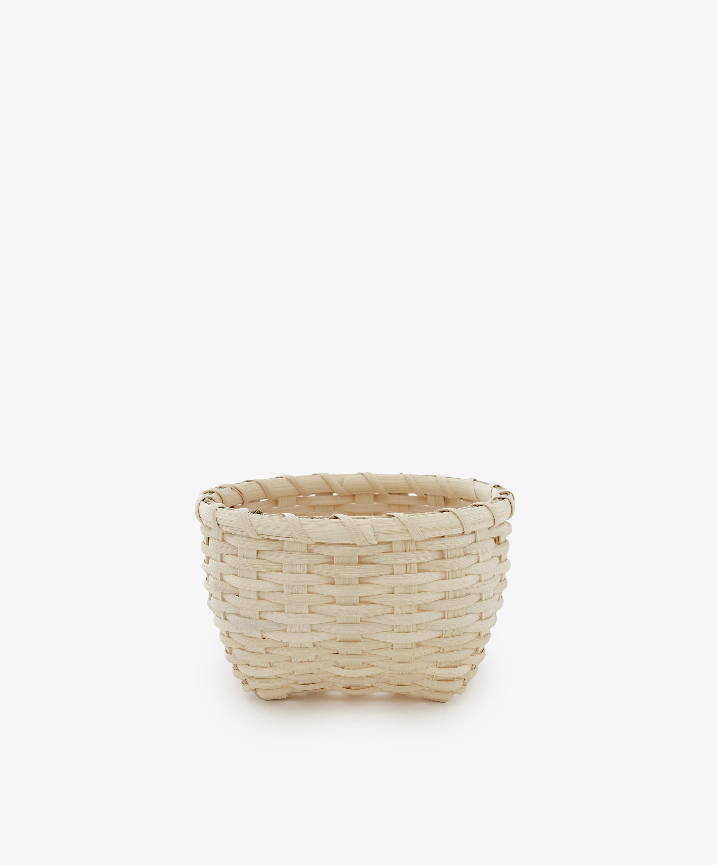 The Little Love Basket, crafted from light-colored woven materials, is displayed at the center of a plain white background.