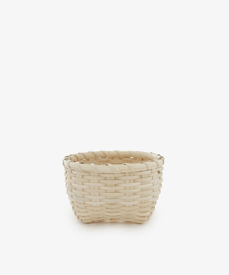 The Little Love Basket, crafted from light-colored woven materials, is displayed at the center of a plain white background.
