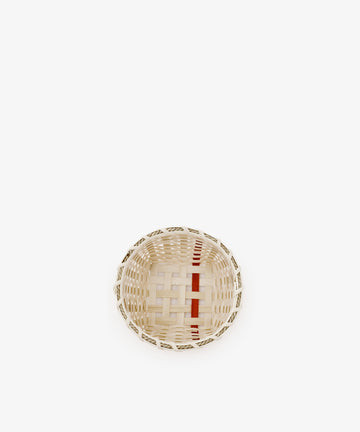 The Little Love Basket, a small, round handwoven piece featuring natural and red accents, is centered on a plain white background.