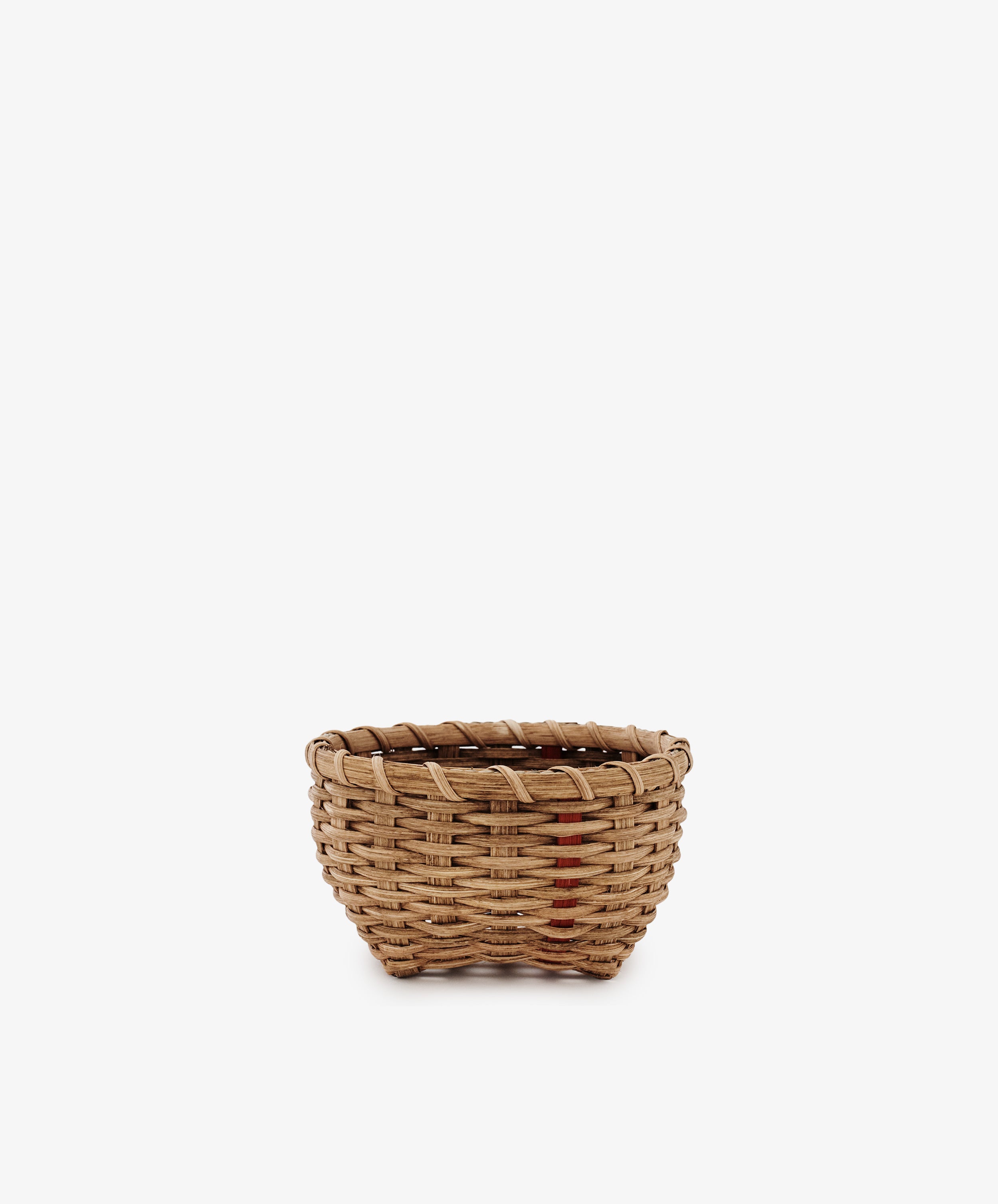 The Little Love Basket is a small, round handwoven basket with a simple design, shown against a plain white background.