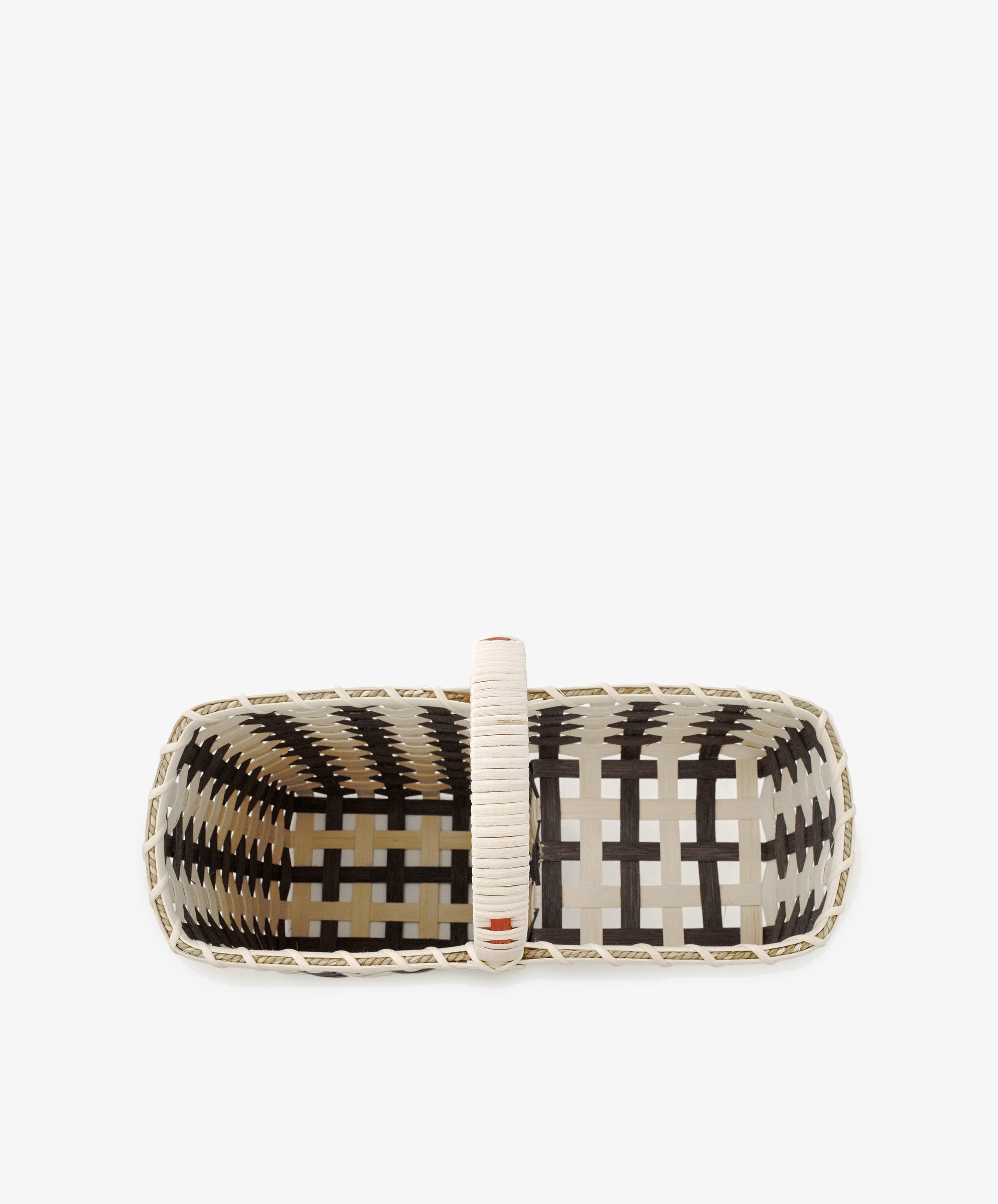 The Stair Tote is a rectangular handwoven basket with a single handle, shown from above, featuring a cream and dark brown checkered pattern—perfect as a stylish storage solution or stair basket for your home.