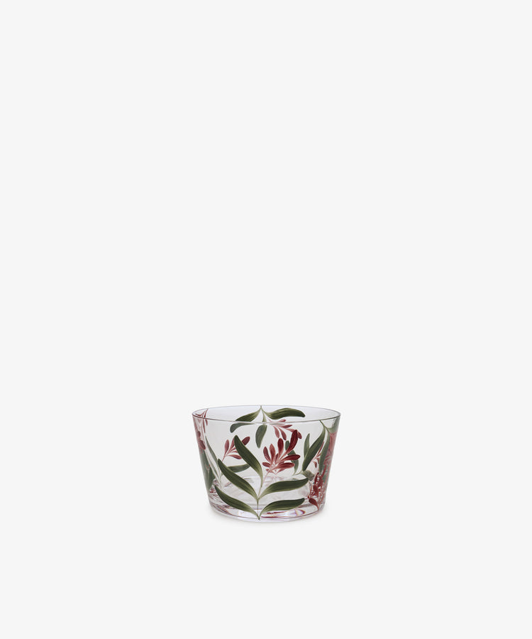The Botanical Pinch Pot, a small clear glass vessel hand-painted with green leaves and red flowers, is centered against a plain white background—an enchanting tabletop accent.