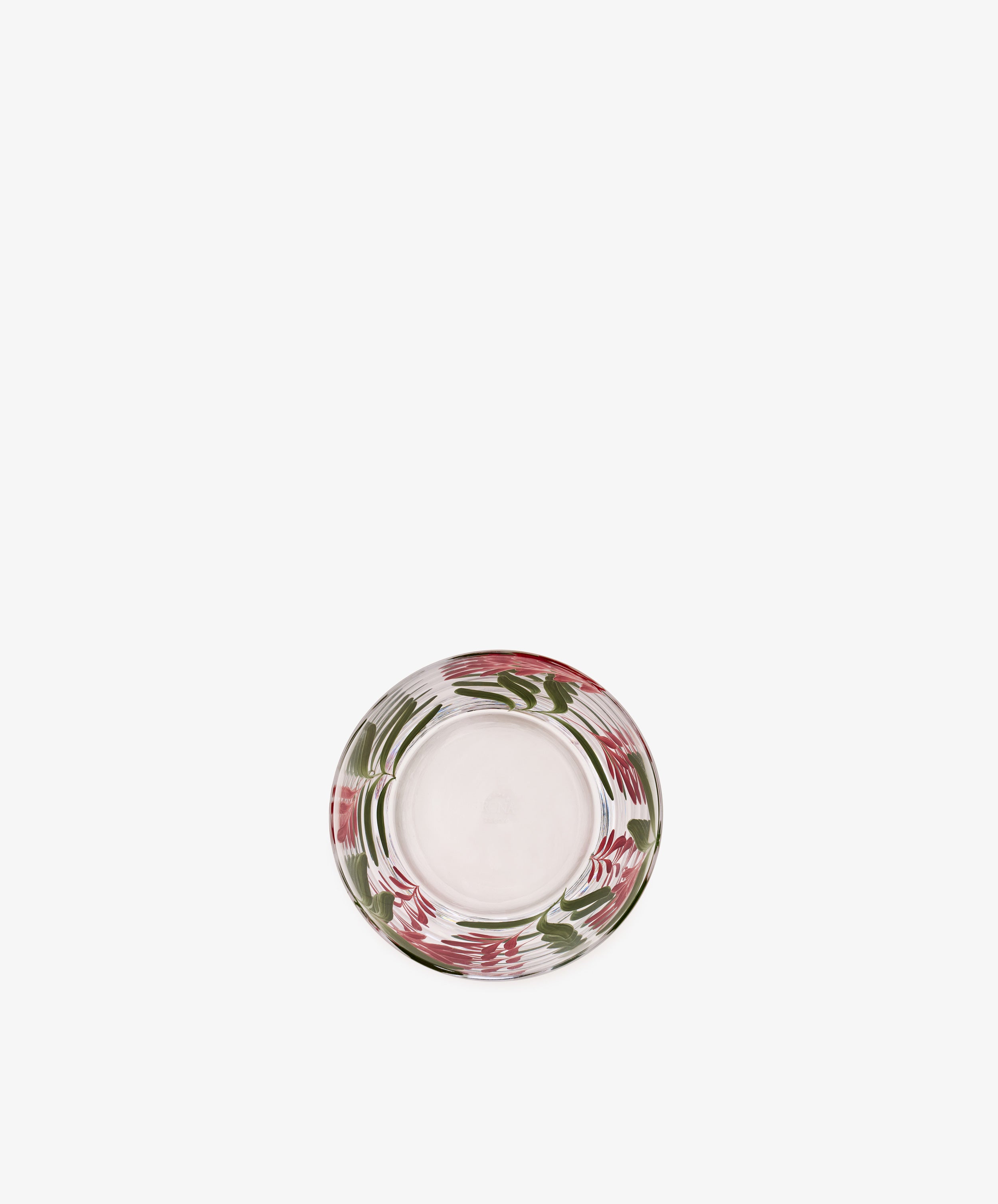 The Botanical Pinch Pot, a round glass plate with a clear center and a border adorned in hand-painted swirls of red, pink, and green, is elegantly photographed against a white background—an exquisite tabletop accoutrement for any setting.
