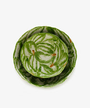 The Nesting Bundle: Two Italian clay bowls with a green leaf pattern and brown accents, displayed one nested inside the other on a white background.