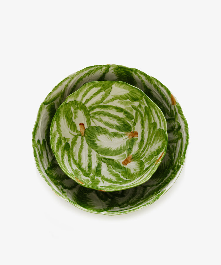 The Nesting Bundle: Two Italian clay bowls with a green leaf pattern and brown accents, displayed one nested inside the other on a white background.