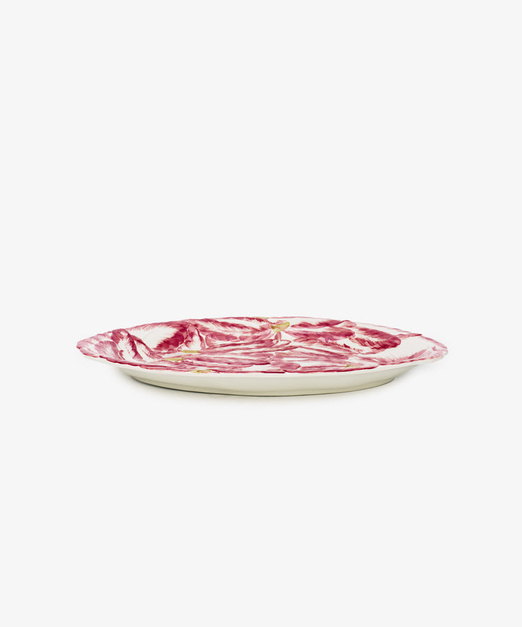The Radicchio Oval Serving Platter is a ceramic dish with a marbled red and white design and a slightly irregular rim, displayed from a side angle on a white background.