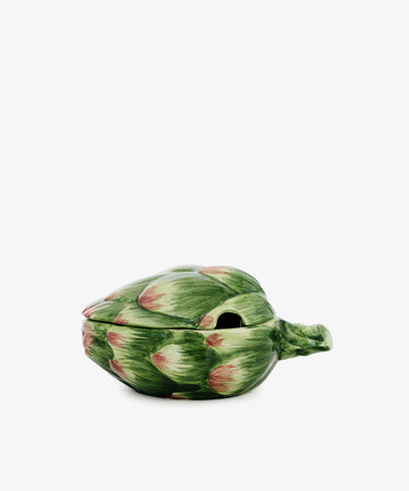 The Artichoke Sauce Bowl, designed as a ceramic artichoke with a removable lid and stem handle, adds Italian charm to your kitchen decor. Presented against a plain white background.