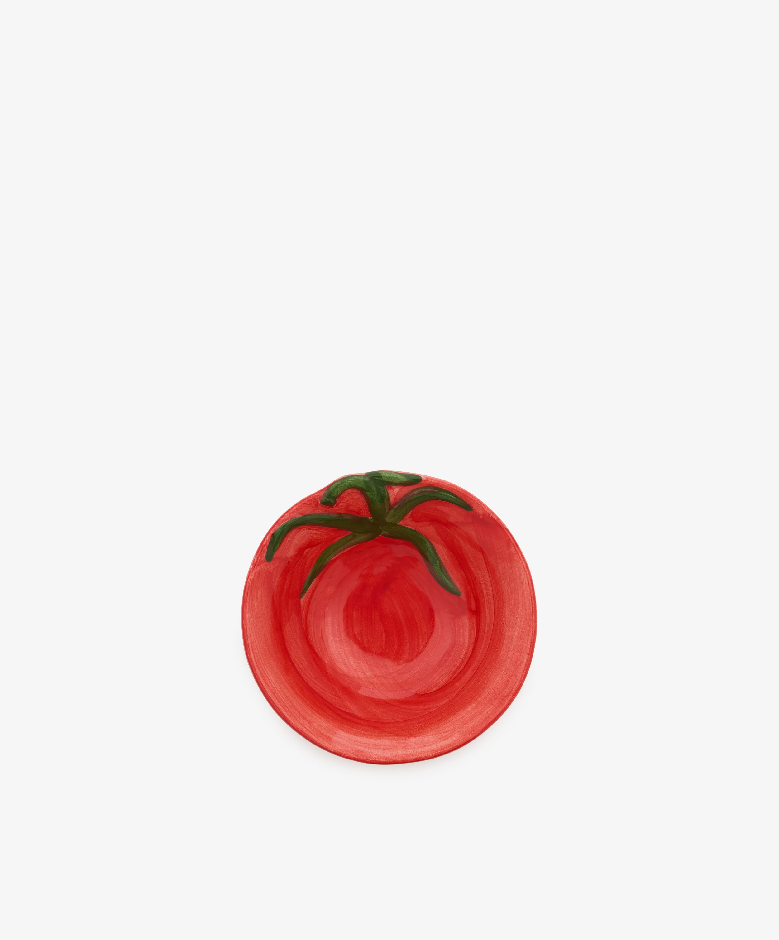 Introducing the Tomato Bowl: a small ceramic dish painted red with a green stem motif to mimic the look of a ripe tomato. Placed on a plain white background, its overripe glaze lends rustic charm to this whimsical piece—perfect as a playful accent atop any Italian farmhouse sideboard.