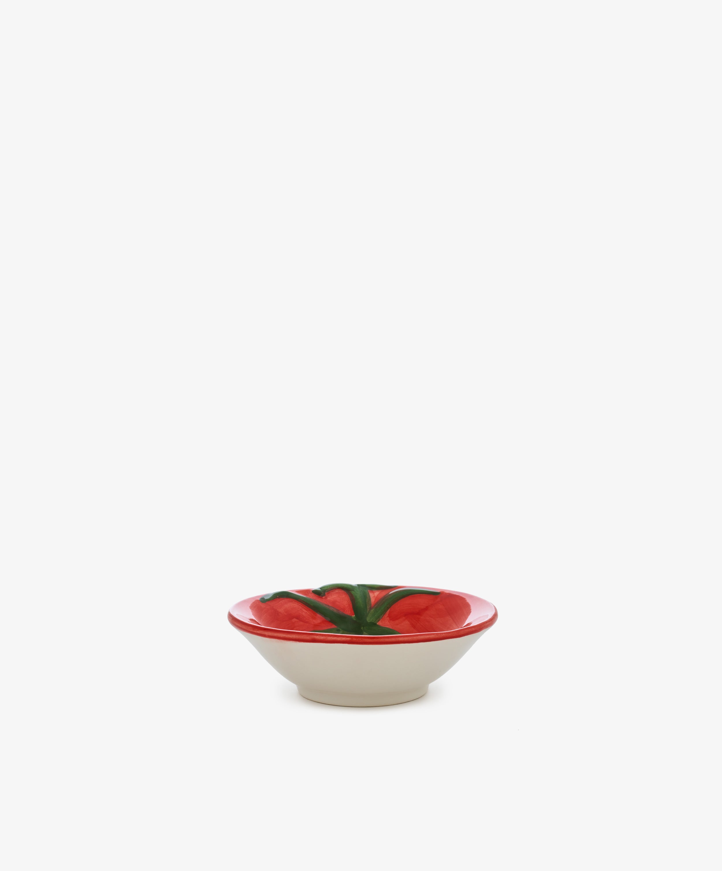 The Tomato Bowl features a vibrant red tomato design on the inside, evoking the charm of classic Italian farmhouse tableware, and is showcased against a plain white background.