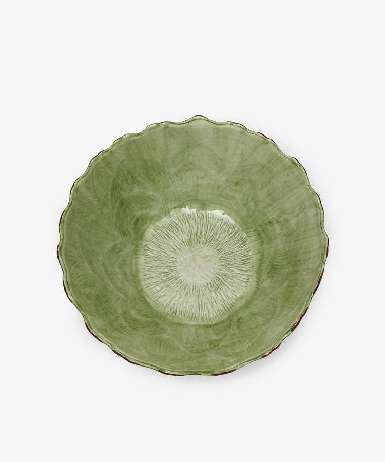 The Artichoke Serving Bowl is green ceramic with a scalloped edge and textured radial pattern inside, hand-finished and shown from above on a white background.