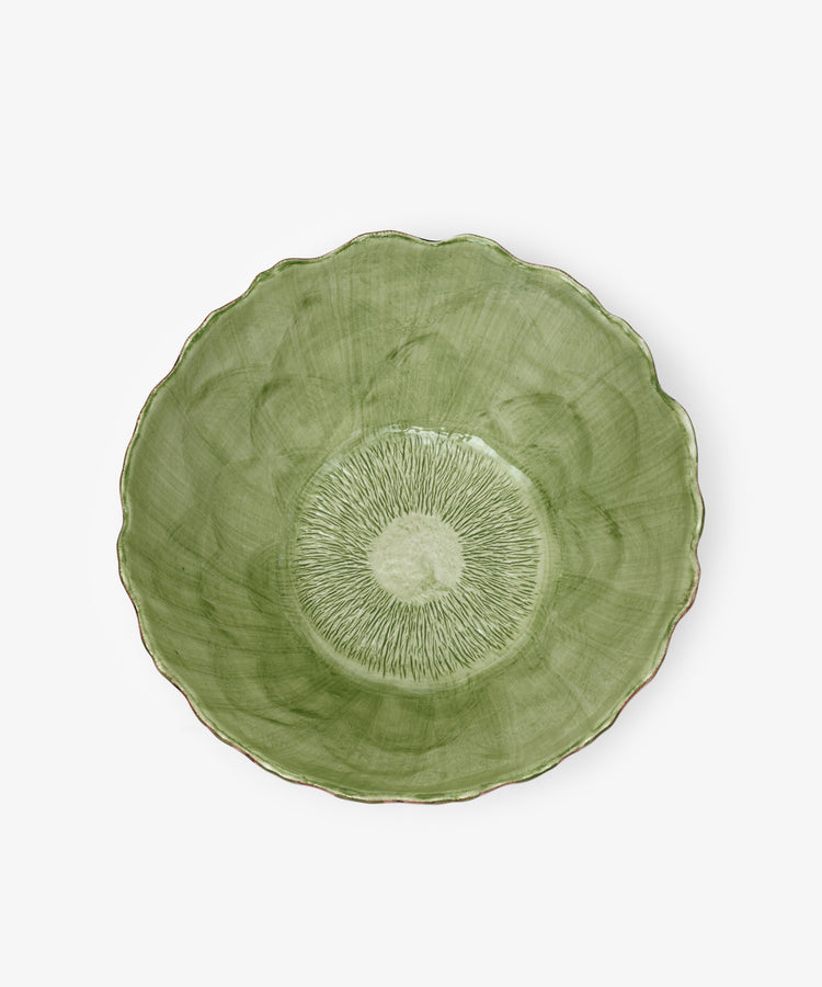 The Artichoke Serving Bowl is a hand-finished green ceramic piece with a scalloped edge and textured, radiating center pattern, viewed from above.