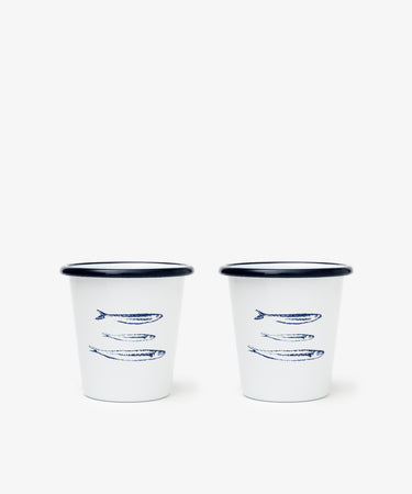 The Il Pesce Enamel Cup Set of 2 features lightweight, durable cups with blue rims and three sardine fish illustrations, making them a charming addition to any mug collection.