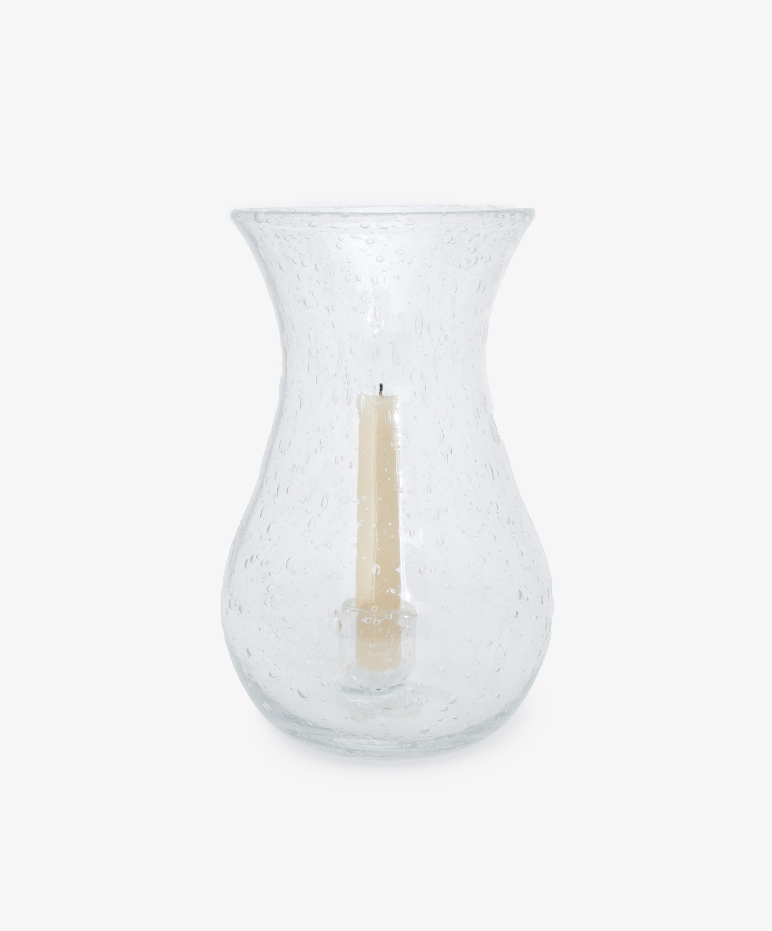 Lauren Hurricane Lamp. Clear bubble glass vessel shown with white taper candle inside.