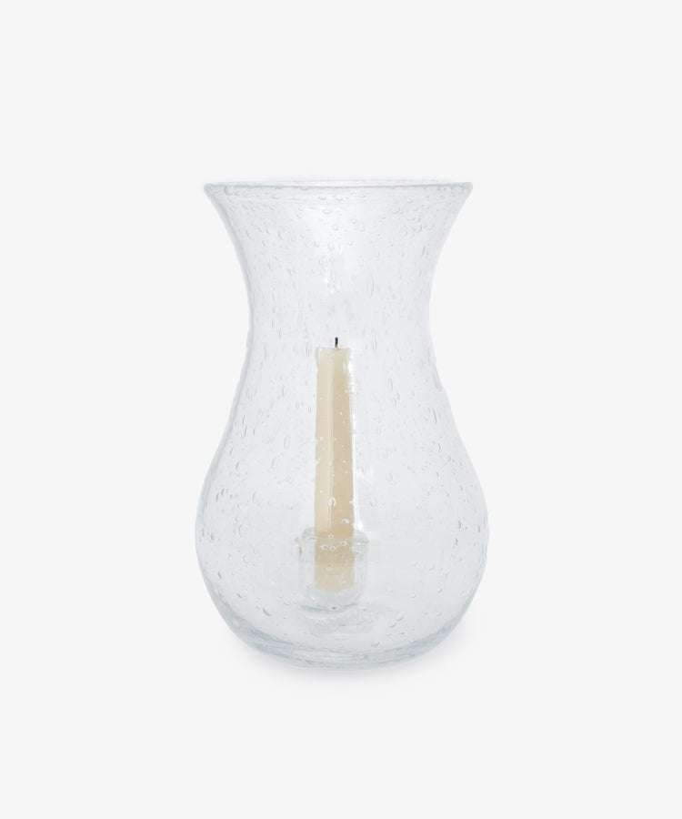 Lauren Hurricane Lamp. Clear bubble glass vessel shown with white taper candle inside.