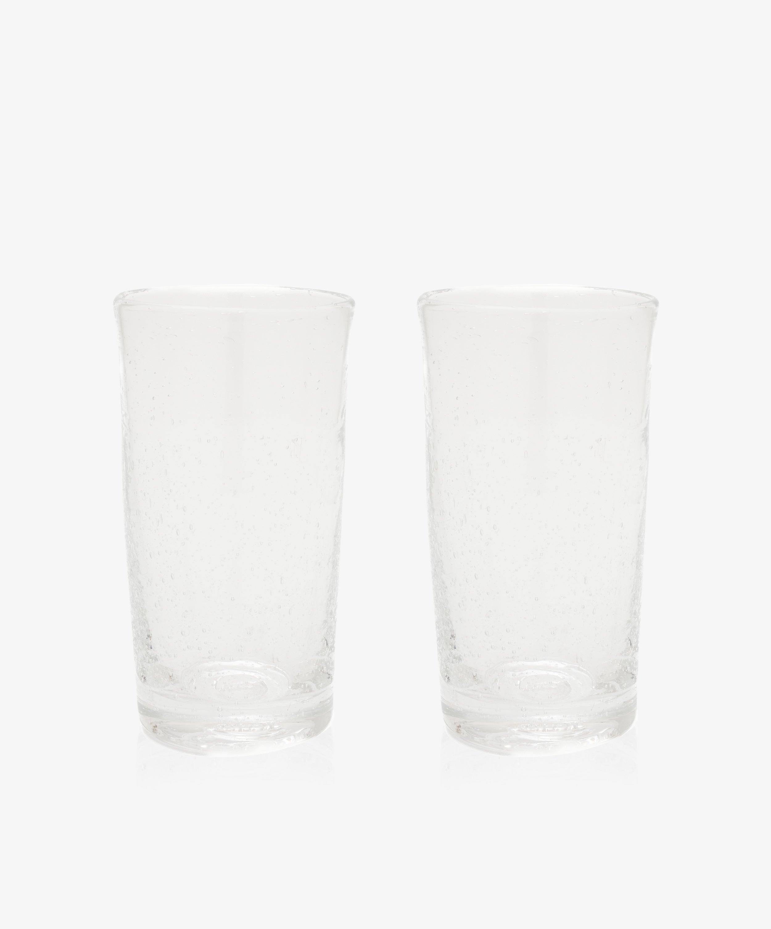 The Lauren Juice Glass, Set of 2, features two tall glass tumblers with a subtle textured pattern, displayed side by side on a plain white background.
