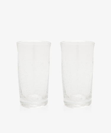 The Lauren Juice Glass, Set of 2, features two tall glass tumblers with a subtle textured pattern, displayed side by side on a plain white background.