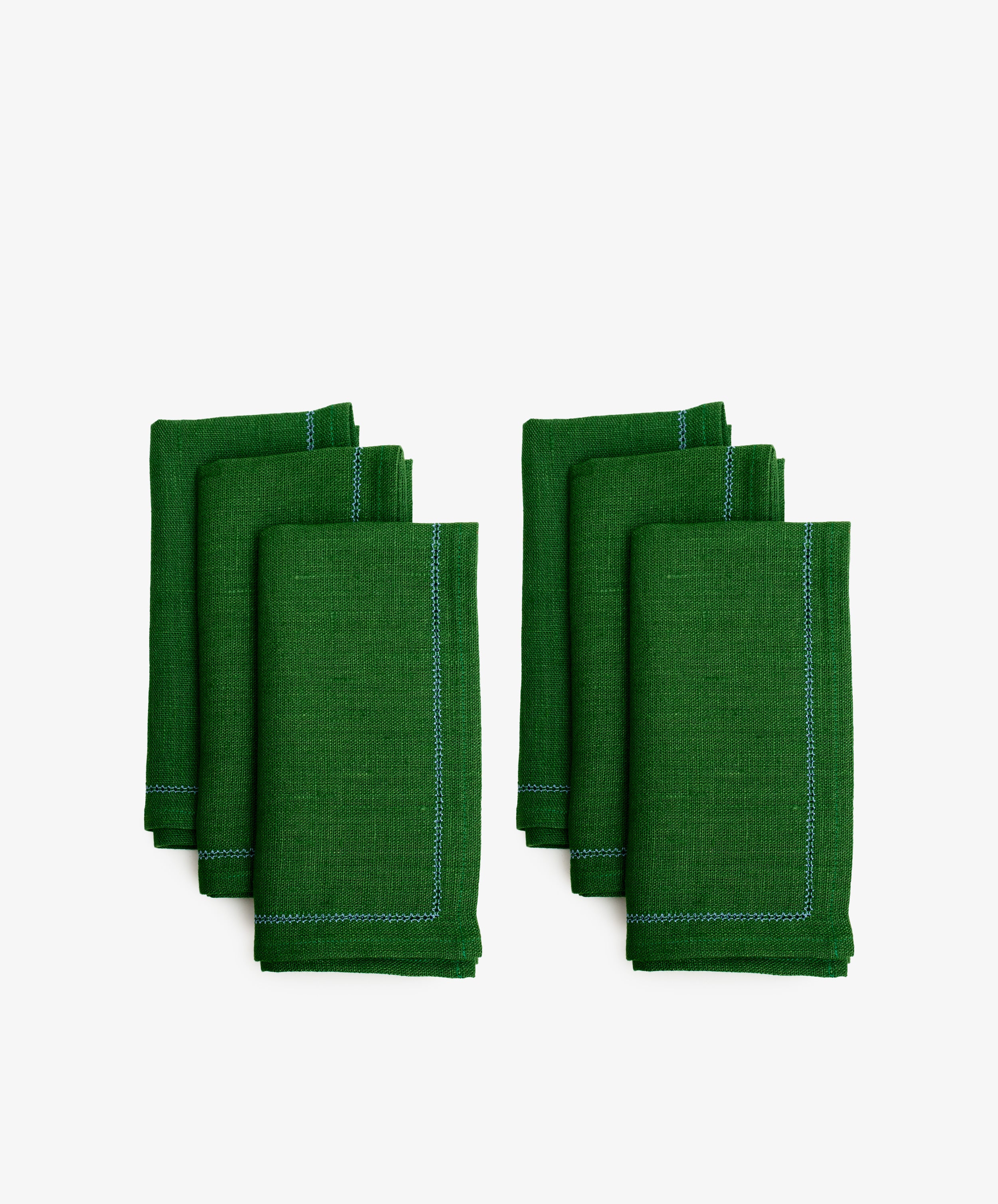 Magnetic Color Field Napkin. Two rows of three folded rectangular napkins in green linen with stitching.