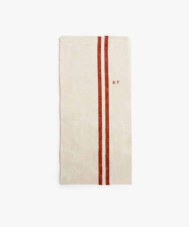 French Vintage Striped Tea Towel. Rectangular folded white linen napkin with two rust-colored stripes and 