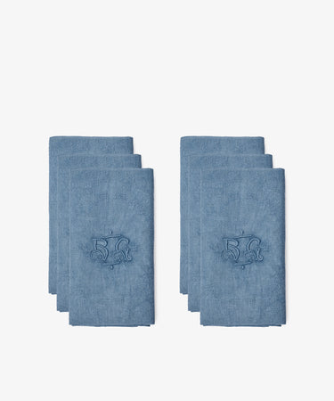 Two stacks of Vintage Embroidered Napkins, Set of 6, each blue and French linen with the number 52 and a decorative design, are displayed on a white background.