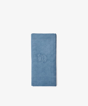 A set of six vintage embroidered blue linen napkins made from European flax, each featuring a letter 