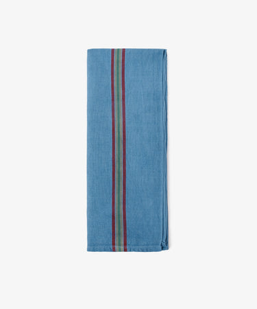 A folded French Vintage Tea Towel, blue in color, with three vertical stripes—green, red, and black—running down the center, evokes classic linen tea towels and is displayed on a white background.