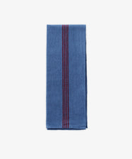 The French Vintage Tea Towel features neat blue fabric with bold red vertical center stripes, evoking classic Provence linen. Set on a plain white background, it adds an elegant and timeless accent to any kitchen decor.