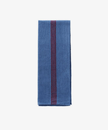 The French Vintage Tea Towel features neat blue fabric with bold red vertical center stripes, evoking classic Provence linen. Set on a plain white background, it adds an elegant and timeless accent to any kitchen decor.