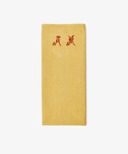 The French Vintage Tea Towel features a folded mustard yellow design with red embroidered 