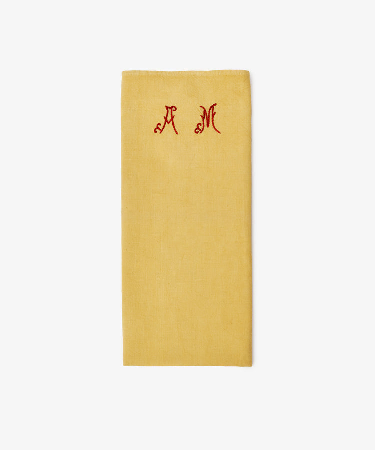 The French Vintage Tea Towel features a folded mustard yellow design with red embroidered 