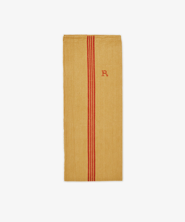 The French Vintage Tea Towel is a rectangular yellow cloth with two vertical red stripes and a small red embroidered 