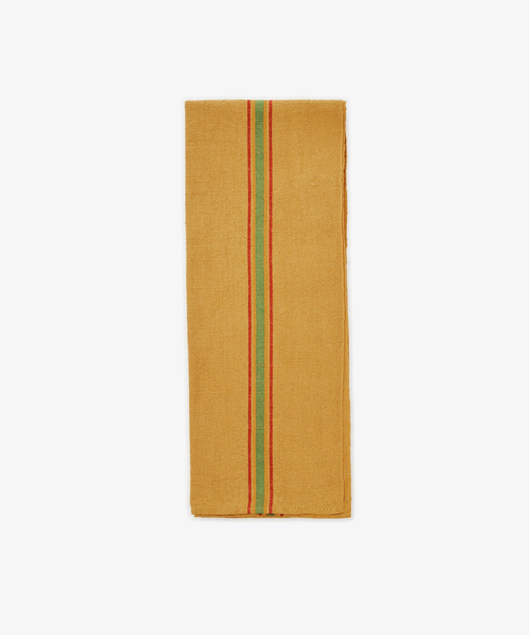 The French Vintage Tea Towel is a rectangular, mustard yellow cloth napkin inspired by vintage linen tea towels with a green and red center stripe—an absorbent and stylish addition to your Provençal pantry.