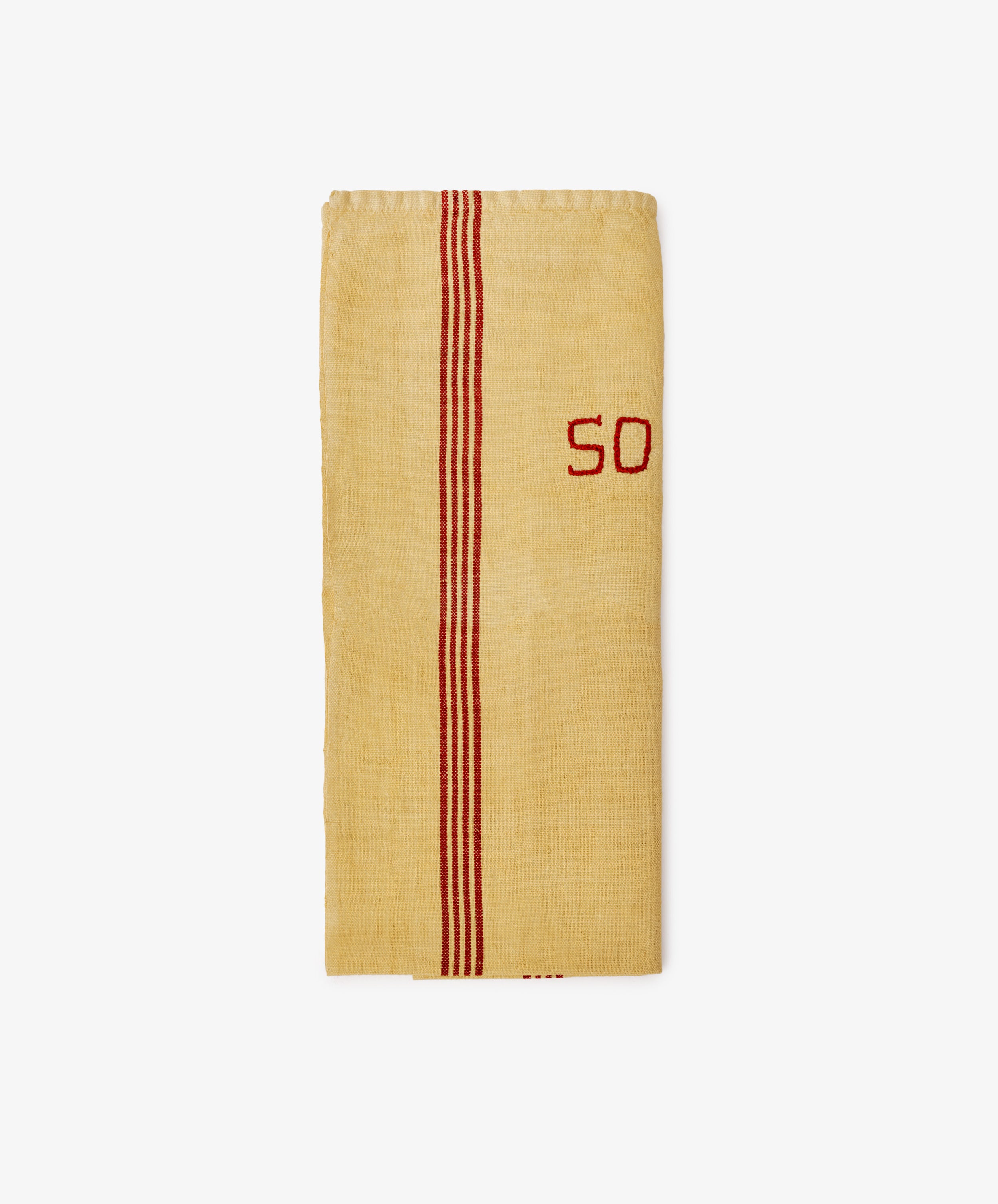 The French Vintage Tea Towel is a folded yellow linen with two red stripes and the number 50 embroidered in red on the right side, adding Provence charm to your kitchen. Shown on a plain white background.