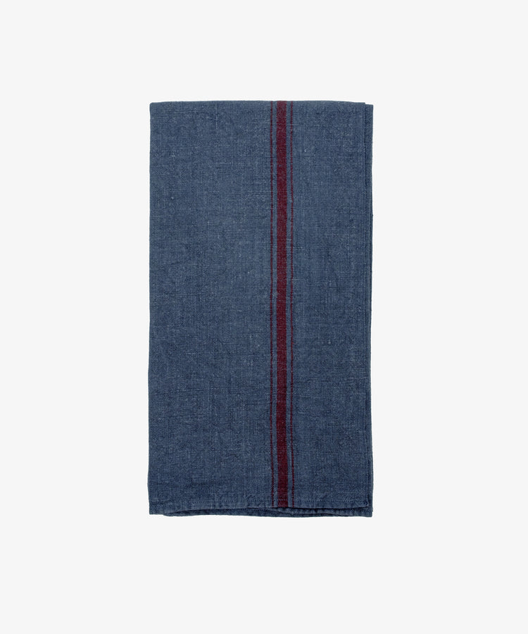 The French Vintage Tea Towel features a folded dark blue cloth with a single vertical maroon stripe, evoking classic Provence linen—ideal for enhancing any kitchen décor and photographed on a plain white background.
