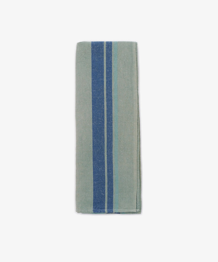 The French Vintage Tea Towel, a folded light gray napkin with two blue vertical stripes and one light blue stripe, evokes classic linen charm and is displayed on a white background.