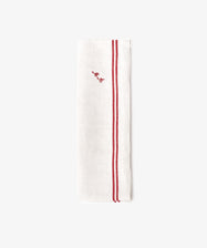 The French Vintage Tea Towel is a white linen napkin folded lengthwise with two parallel red stripes and a small red embroidered script near the top, evoking classic vintage tea towel style.