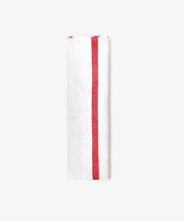 The French Vintage Tea Towel is a white cloth napkin folded lengthwise, featuring a single red vertical stripe near one edge, evoking classic vintage linen style and displayed against a plain light background.