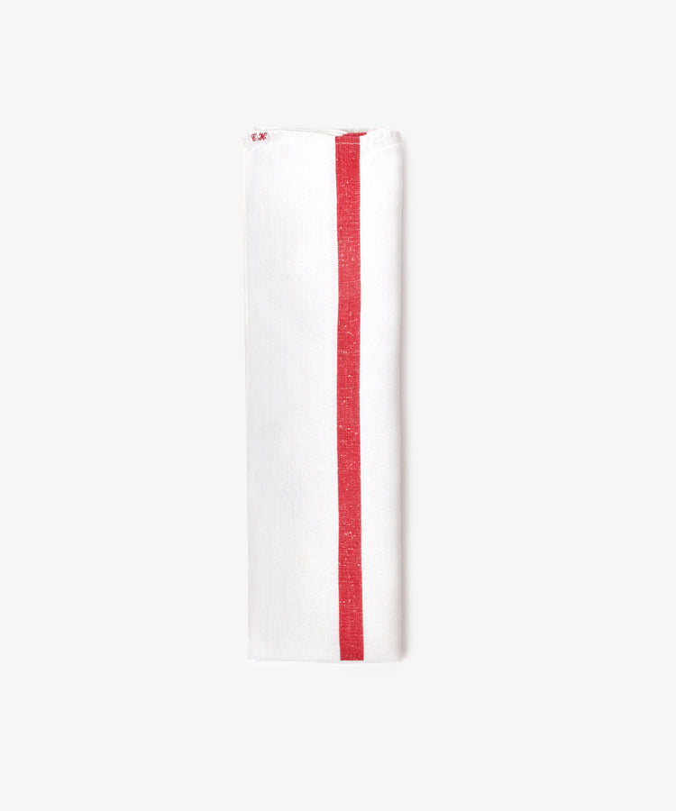 The French Vintage Tea Towel is a white cloth napkin folded lengthwise, featuring a single red vertical stripe near one edge, evoking classic vintage linen style and displayed against a plain light background.