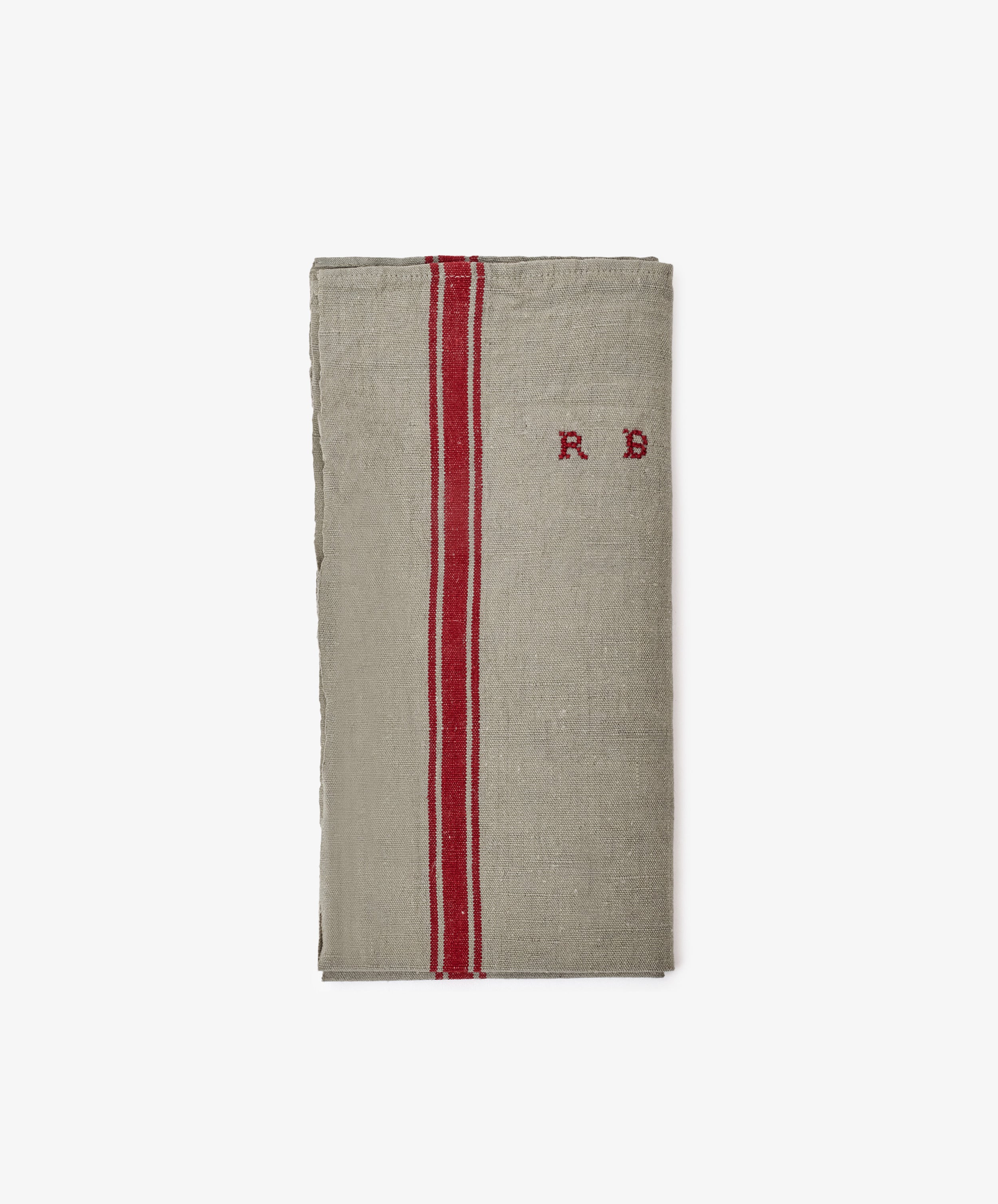 The French Vintage Tea Towel is a folded beige linen with two vertical red stripes and 