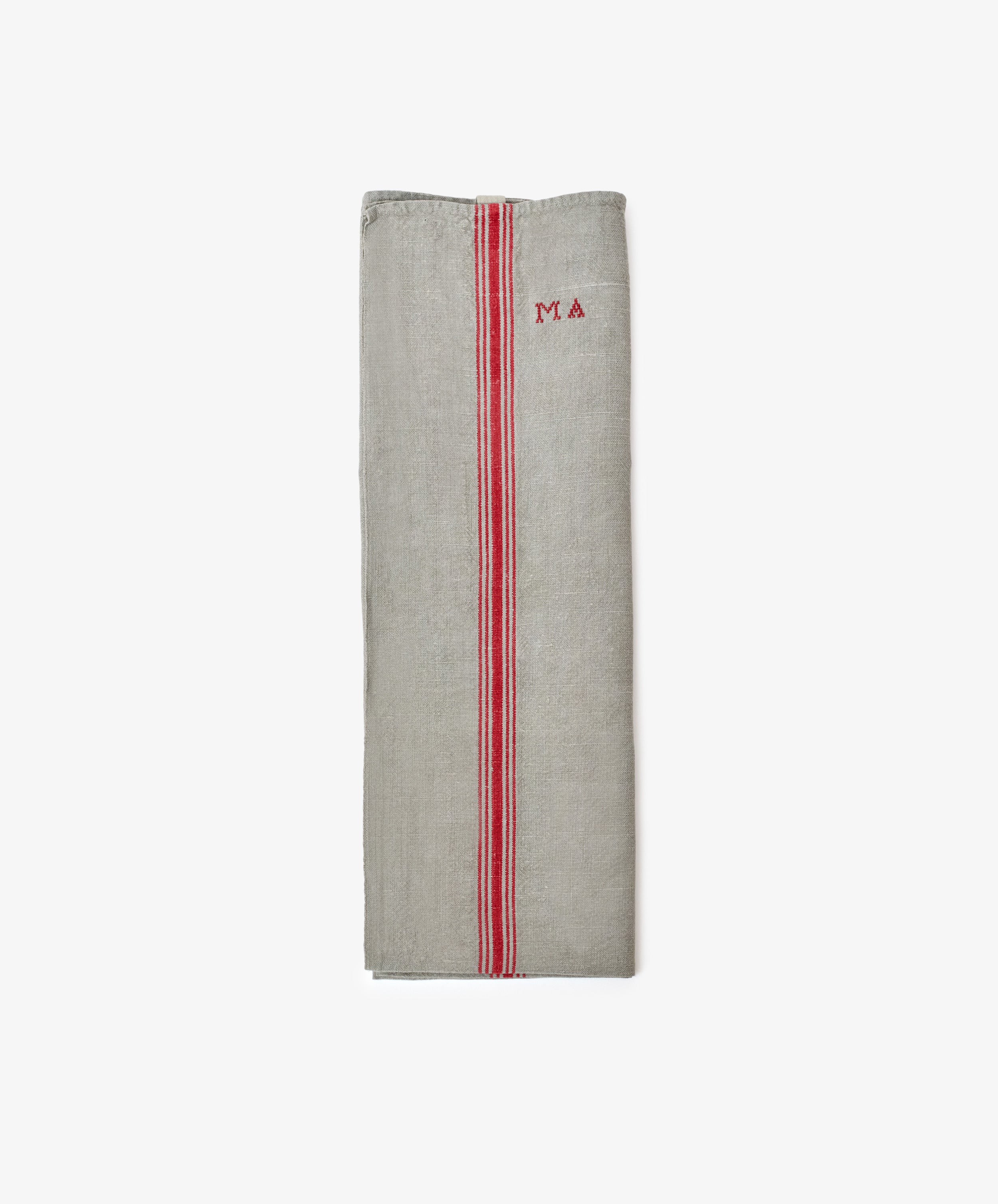The French Vintage Tea Towel, a folded gray linen with red stripes and MA embroidery on the upper right, brings Provence charm to your kitchen.