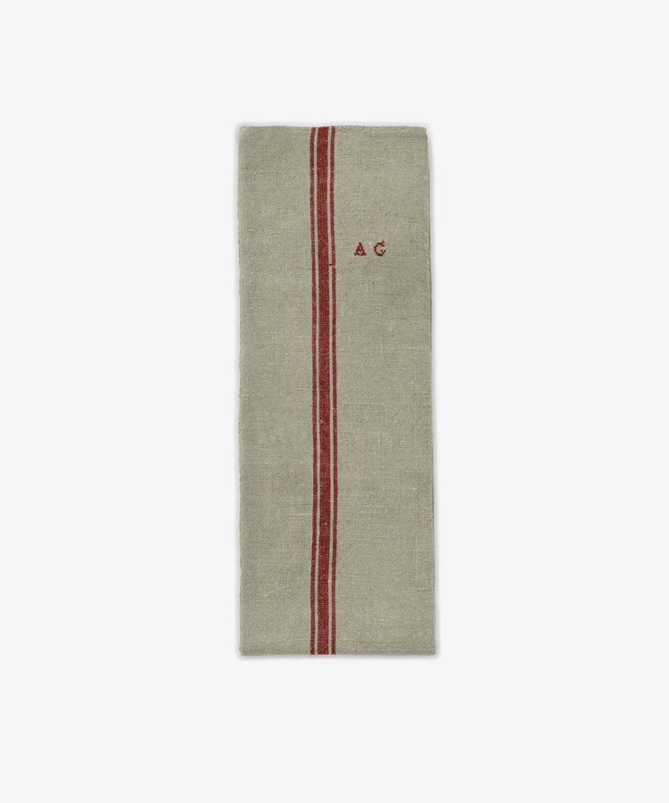 The French Vintage Tea Towel is a rectangular beige linen cloth with a single red vertical stripe and 
