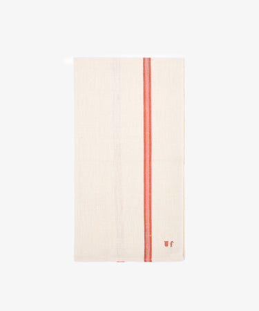 The French Vintage Tea Towel is cream-colored with two vertical red stripes and small embroidered initials in one corner, shown against a plain white background.