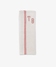 The French Vintage Tea Towel is a folded beige napkin with red embroidered initials 