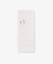 A French Vintage Tea Towel featuring a white folded cloth napkin with 
