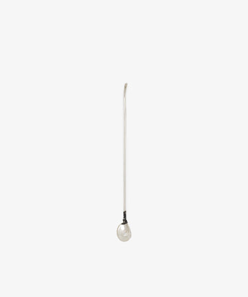 The Oyster Shell Cocktail Stirrer is a long, slender sterling silver stirrer featuring a gentle curve at the top and a round, reflective sphere at the bottom, shown against a plain white background.