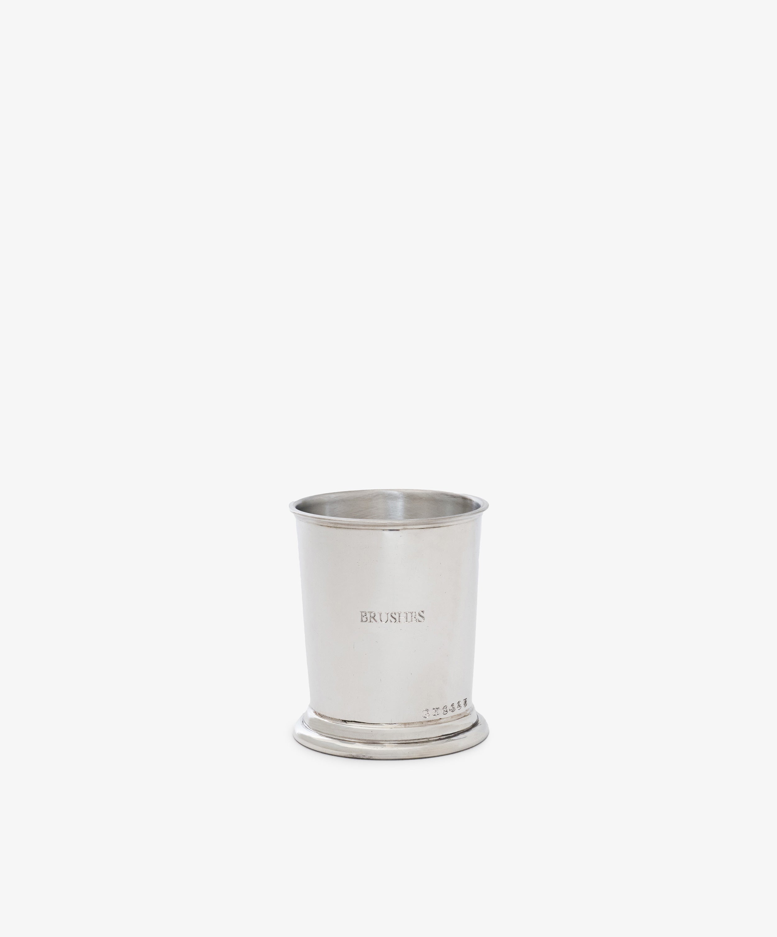 The Jane Brushes Cup is a pewter holder engraved with BRUSH TIPS, ideal for storing makeup brushes, shown on a plain white background.