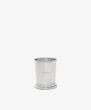 The Jane Brushes Cup is a pewter holder engraved with BRUSH TIPS, ideal for storing makeup brushes, shown on a plain white background.